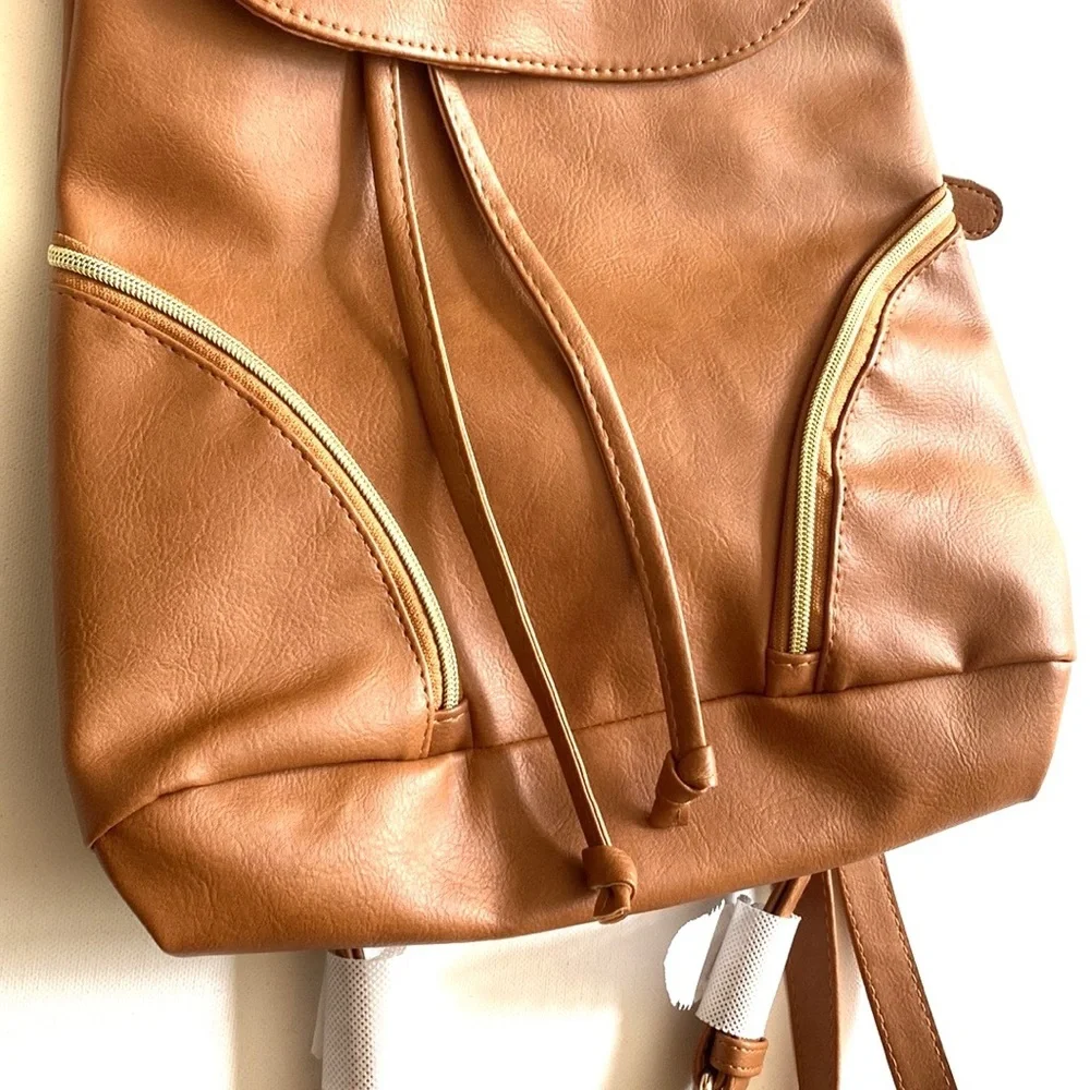 Brown backpack with zipper‎ accented detailing on front, NWOT